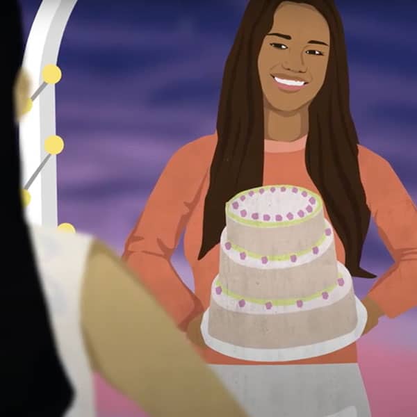 A woman purchasing a fancy cake