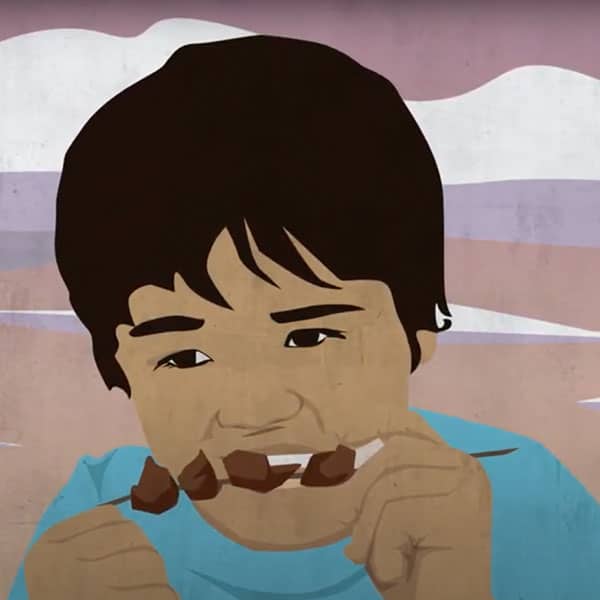 Child eating a shish kabob